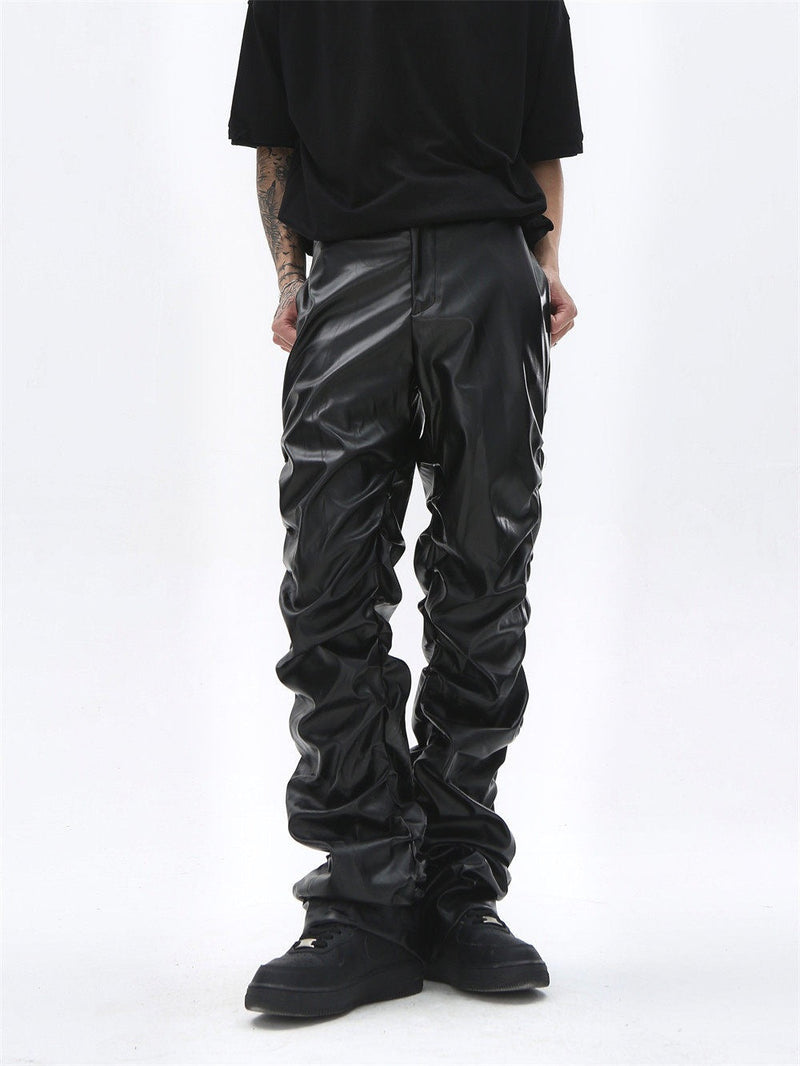 Black faux leather straight-leg pants worn front view, showing heavy ruched legs and cuffs