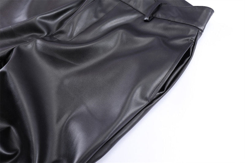 Close-up of black faux leather pants front hip and side seam with smooth glossy finish