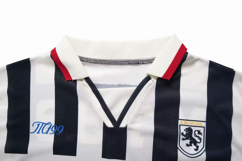 Retro black and white striped soccer jersey with red-trimmed collar and crest patch on the chest