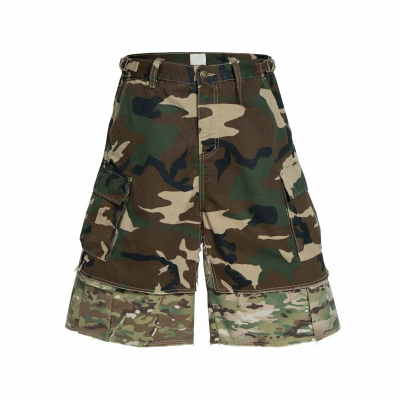 Front view of camouflage cargo shorts with belt loops, flap pockets, and patchwork hem