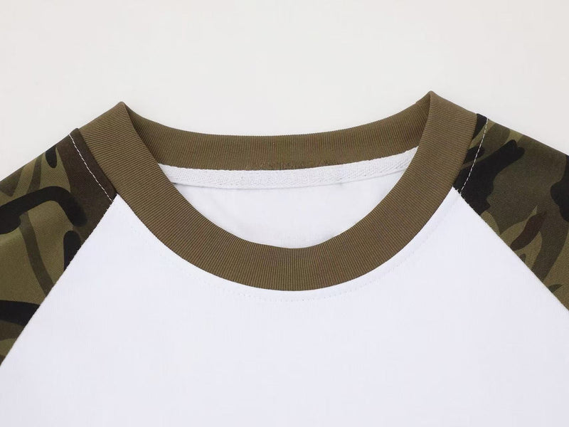 Close-up of crew neck on white raglan tee with olive rib trim and camouflage shoulders