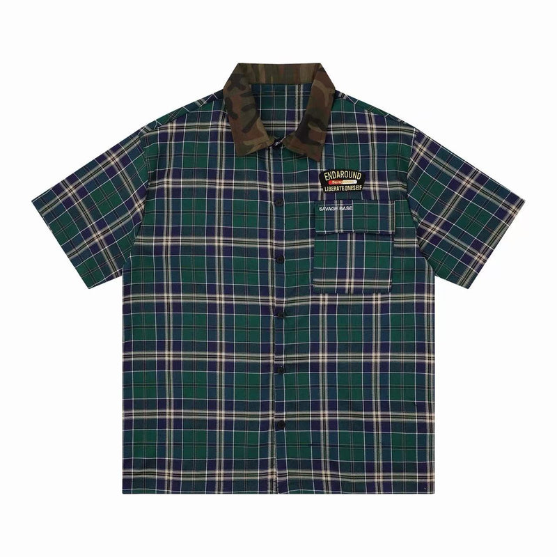 Green and navy plaid short-sleeve shirt with camo collar and chest pocket detail, streetwear style