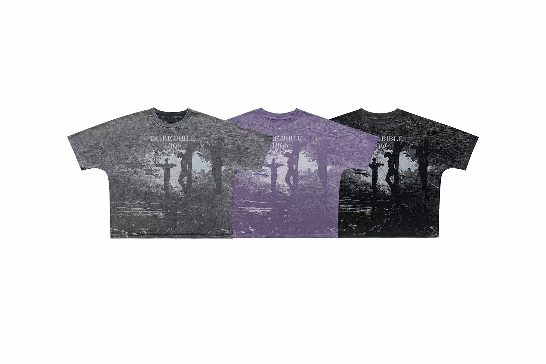 Three vintage washed graphic tees in grey, purple, and black featuring a Gustave Doré 1866 Bible crucifixion engraving print