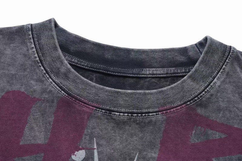 Close-up of a vintage washed dark graphic tee with a ribbed crew neckline and faded goth rock print