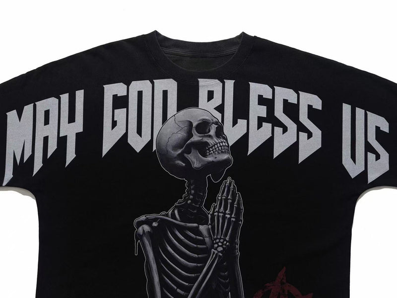 Black oversized gothic tee with praying skeleton graphic and bold May God Bless Us text print
