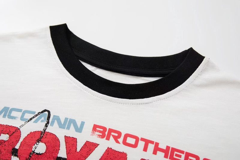 White vintage band graphic tee with black ribbed crew neck and distressed retro concert poster print