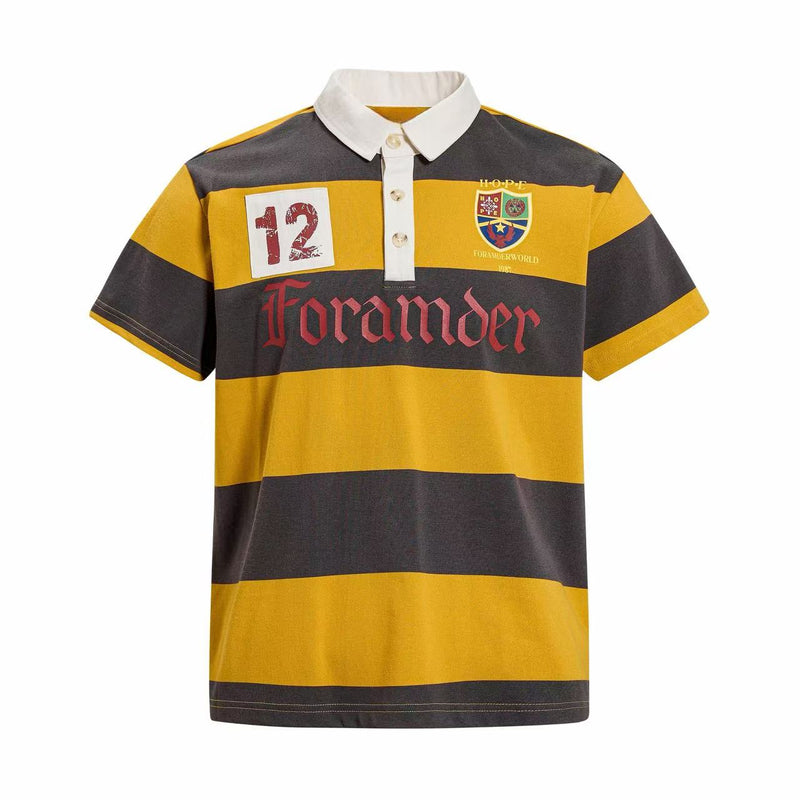 Yellow and black striped rugby polo shirt with white collar, button placket, and vintage graphic chest patches