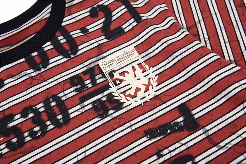 Close-up of a red and white striped streetwear T-shirt with bold graffiti text and Foramnder chest graphic
