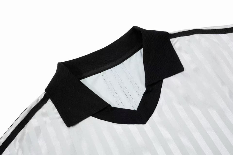 Black-collar white football jersey with subtle striped texture and retro streetwear style detail