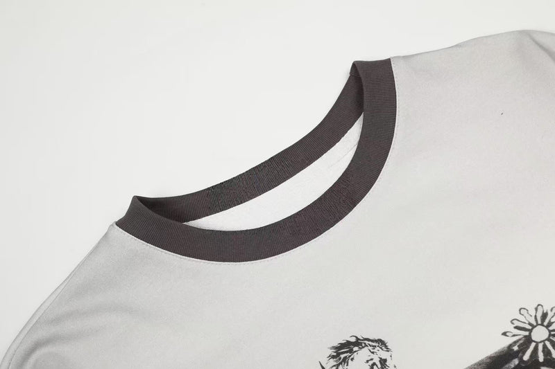 Close-up of ribbed black crew neckline on cream long sleeve tee