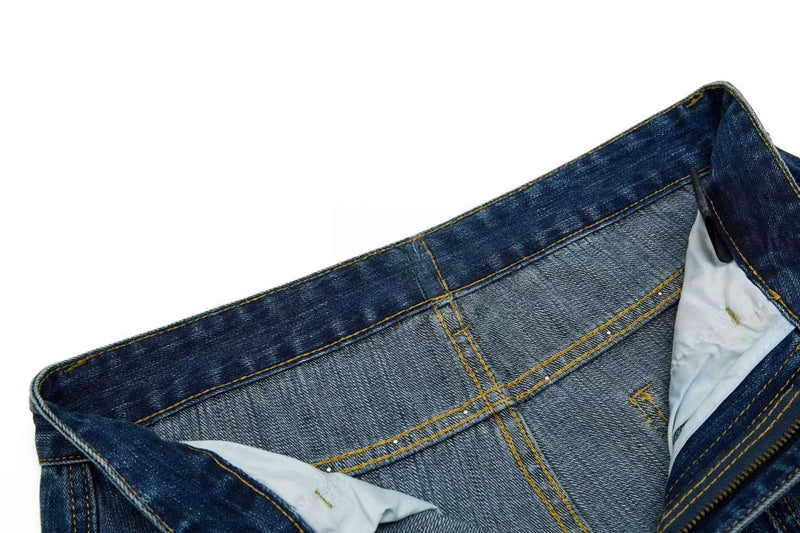 Inside waistband of blue denim jeans with printed label and pocket lining
