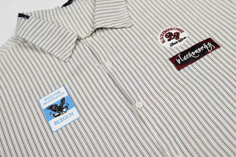 White pinstripe button-up shirt with patch graphics and embroidered streetwear details