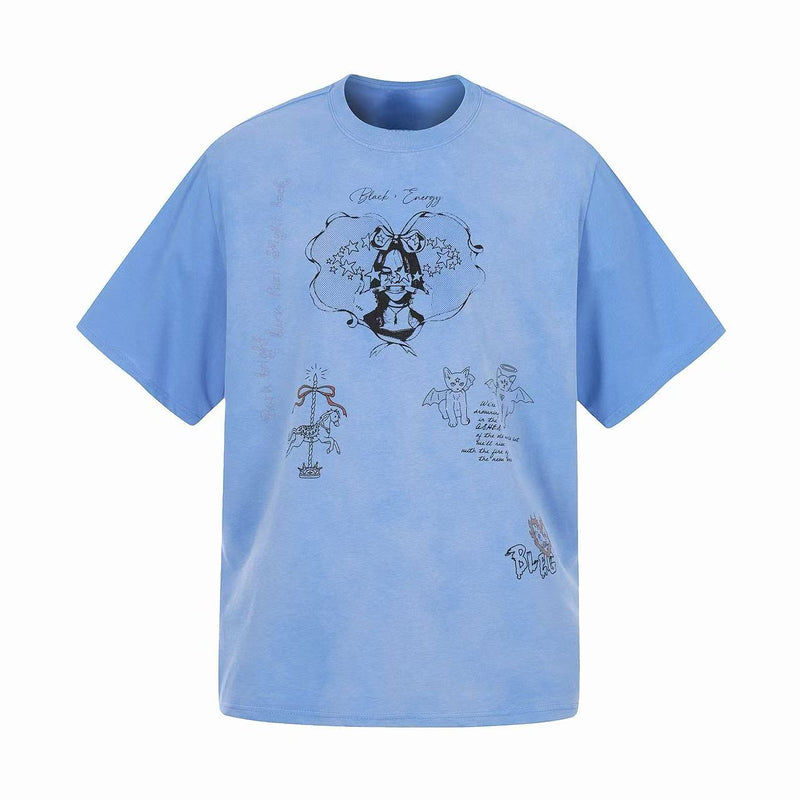 Light blue graphic tee with black sketch prints, star accents, and cute cartoon-style illustrations on the front