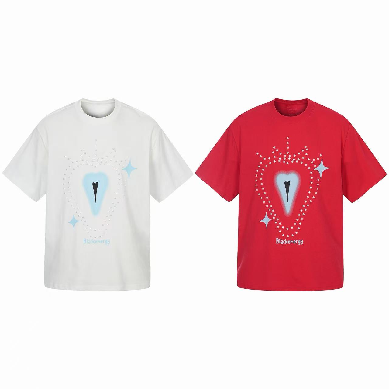 White oversized cotton graphic tee with airbrushed blue heart motif, rhinestone dot detailing, and sparkle accents on a clean