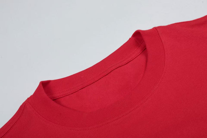 Red crewneck graphic tee with a crystal heart rhinestone dot print and smooth ribbed collar detail