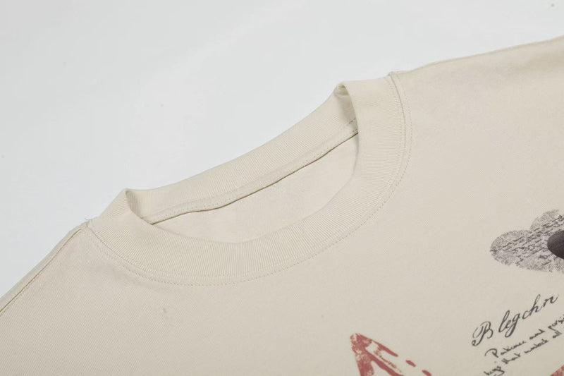 Cream oversized cotton tee with ribbed crew neck and faded star script graphic print