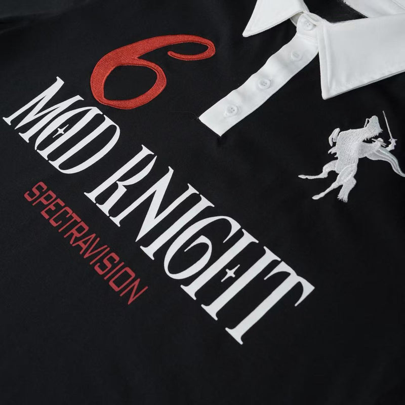 Black graphic polo tee with white contrast collar, red lettering, and embroidered knight motif