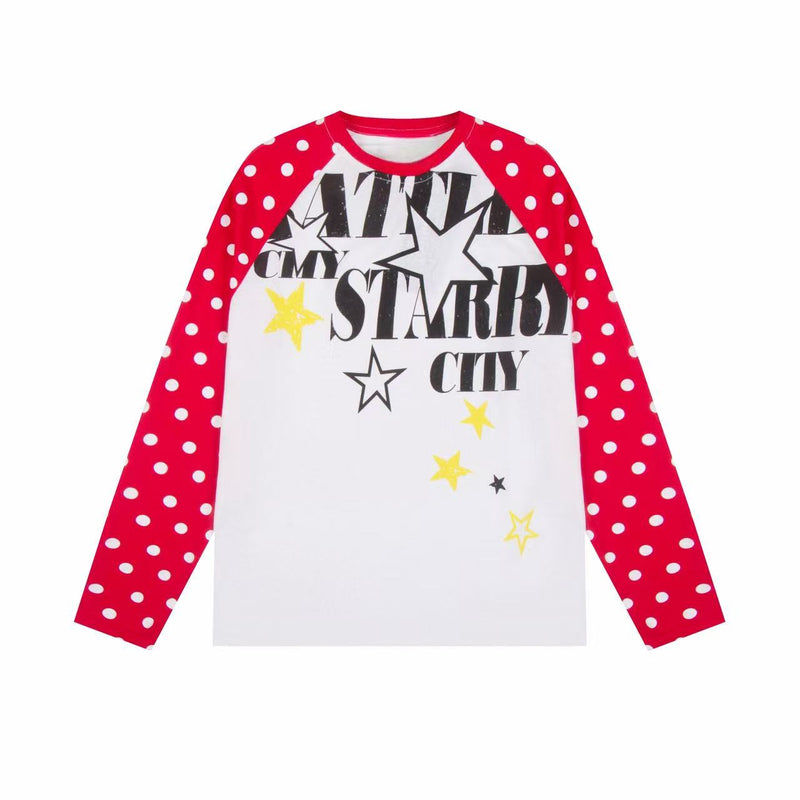 White raglan long sleeve tee with red polka dot sleeves and black and yellow starry city graphic