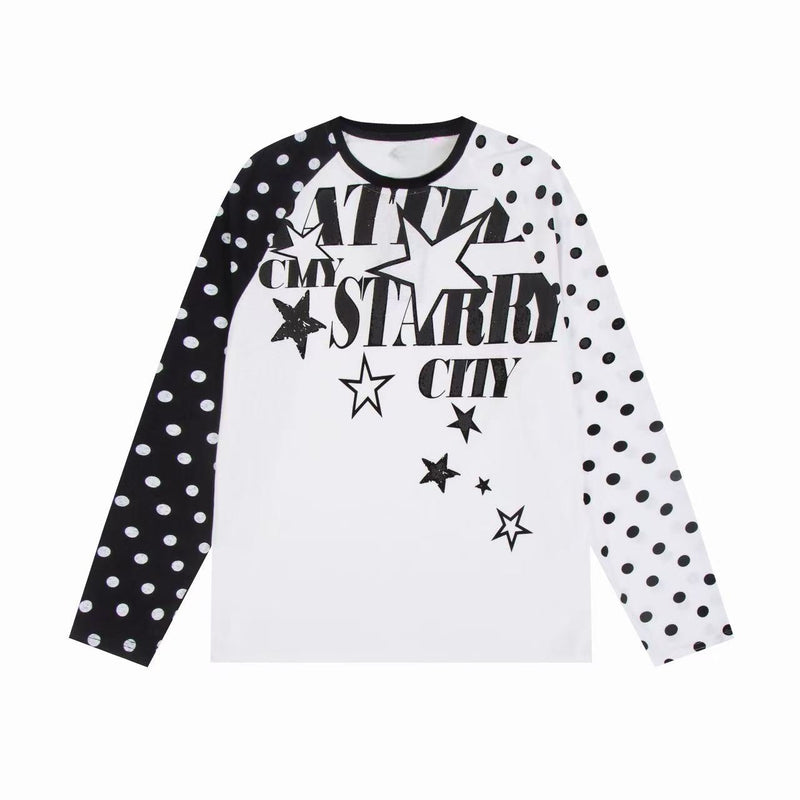 White raglan long sleeve tee with black polka dot sleeves and black starry city graphic on front