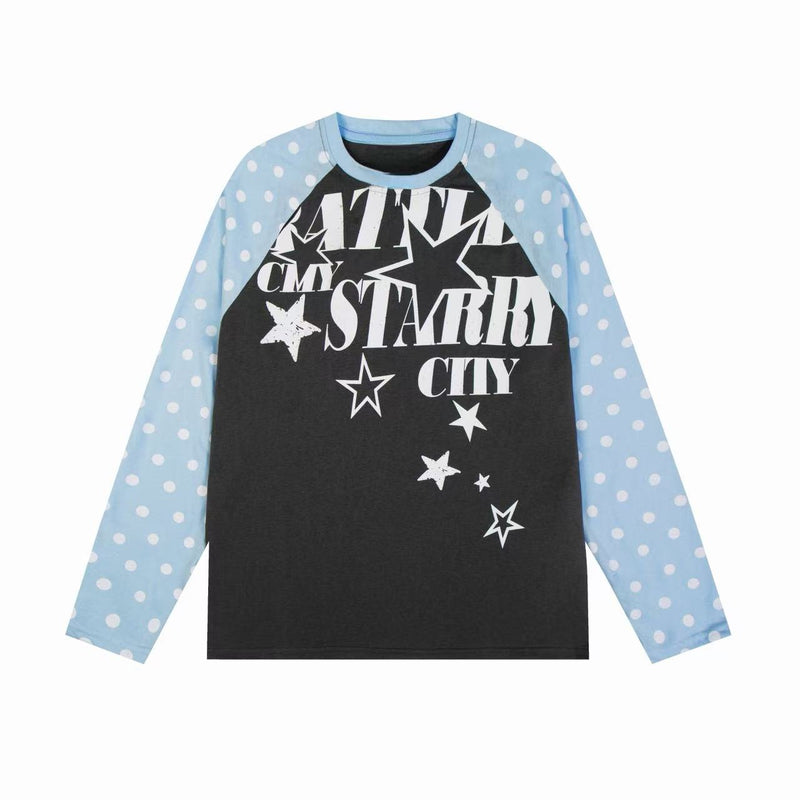 White raglan long sleeve tee with light blue polka dot sleeves and black starry city graphic