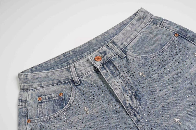 Close-up of light wash jeans front waist with rhinestones and front pocket