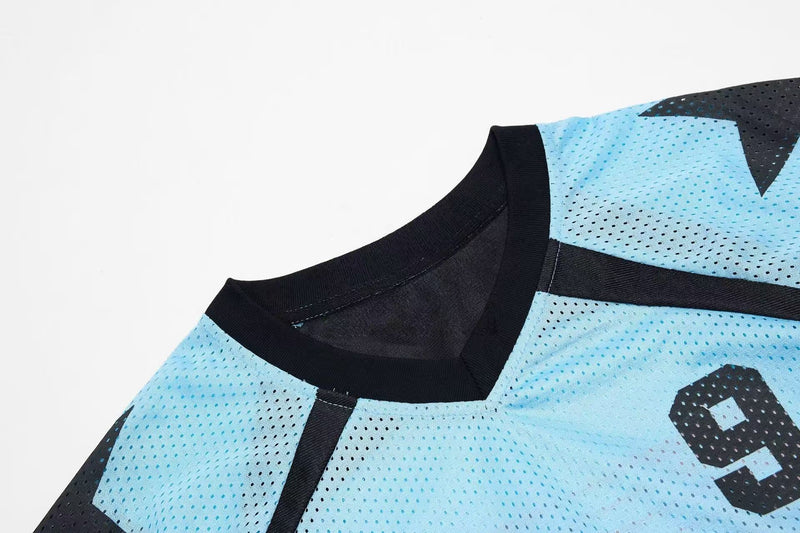 Light blue mesh sports jersey with black ribbed collar and bold number 9 detail, shown in close-up