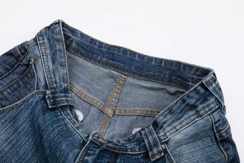 Close-up of the waistband interior and front closure on faded blue denim jeans