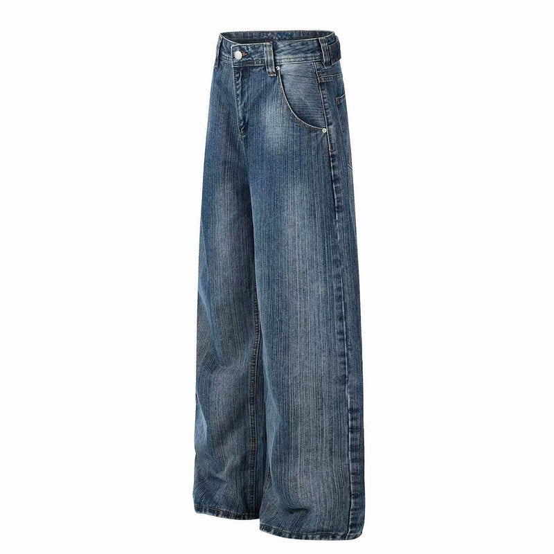 Side view of wide-leg blue denim jeans showing the relaxed leg and curved front pocket