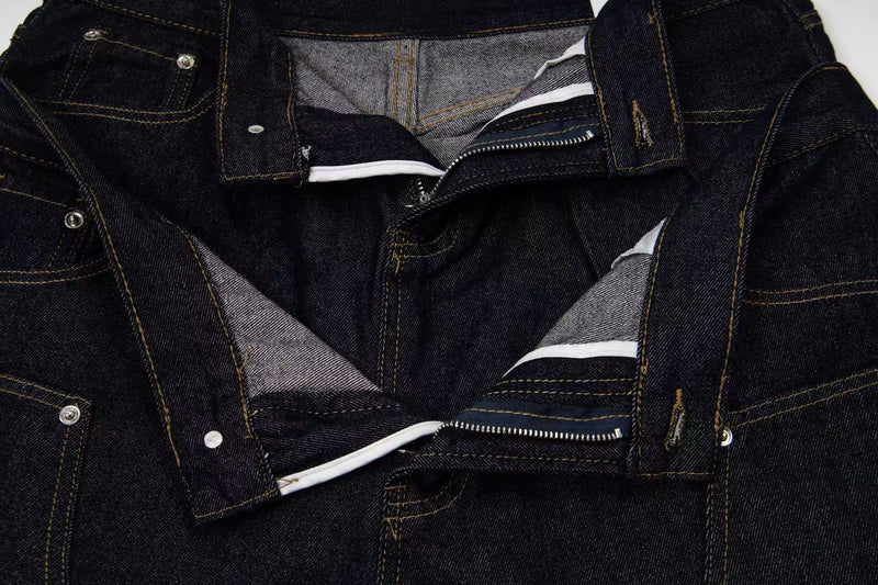 Inside view of denim shorts showing waistband lining, zipper and button closure