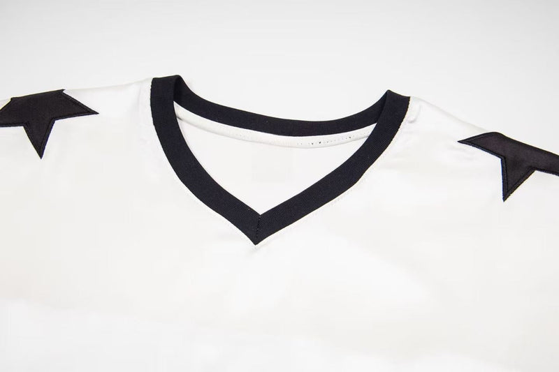 White mesh jersey tee with black V-neck trim and shoulder star patches, varsity-inspired football streetwear style