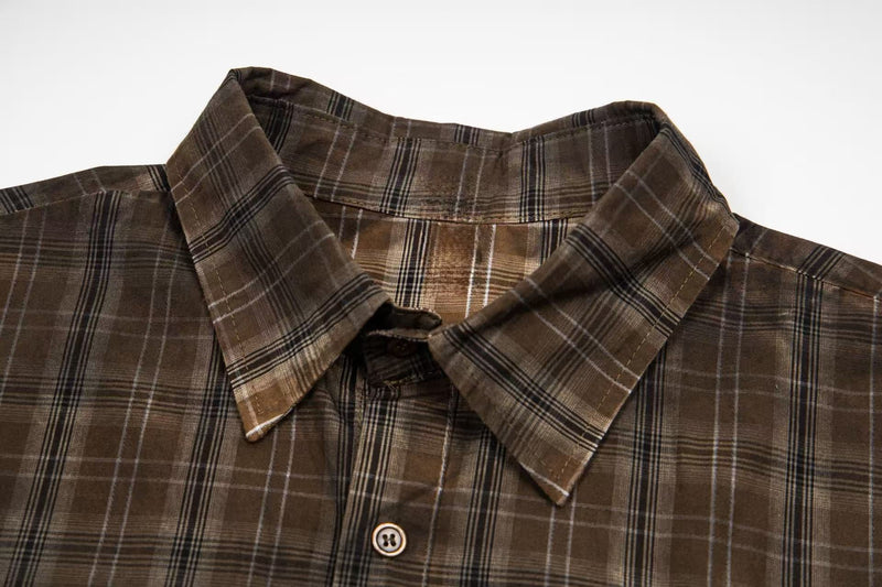 Brown plaid button-up shirt with a pointed collar and vintage retro streetwear style on a white background