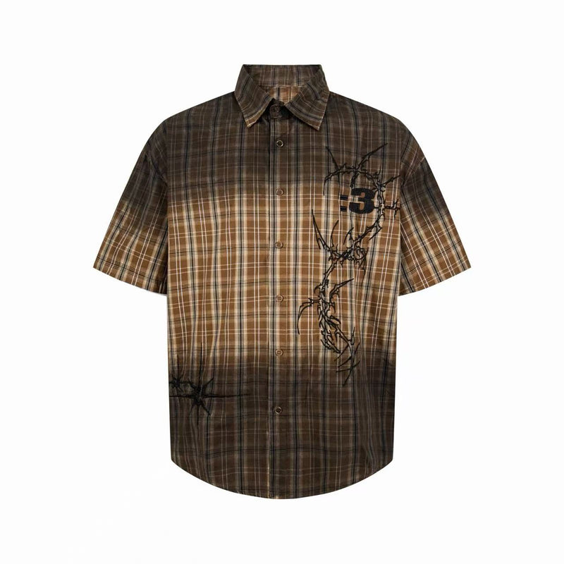 Brown short-sleeve plaid button-up shirt with distressed graphic print and vintage streetwear style