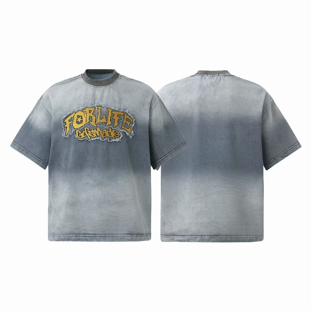 Front and back view of a grey vintage washed oversized t-shirt with gold graffiti-style embroidered patch on chest