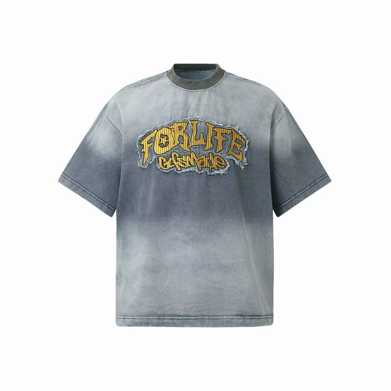 Vintage washed gray oversized T-shirt with distressed yellow embroidered graphic on the chest