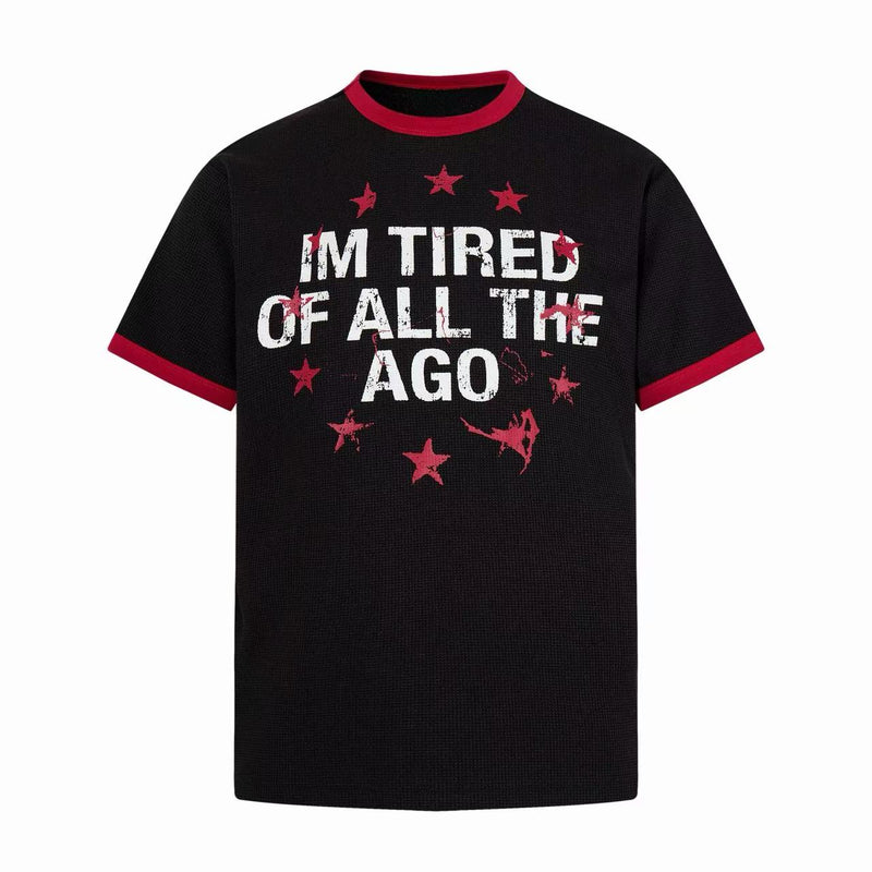 Black ringer T-shirt with red trim and distressed I’m Tired of All the Ago graphic and stars on the chest