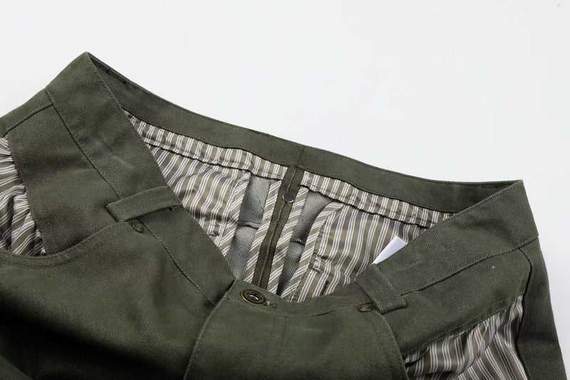 Waistband close-up of army green pants with striped lining and front button closure