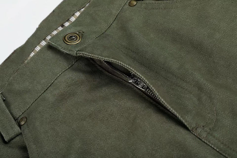 Close-up of army green pants front pocket with striped lining and metal snap