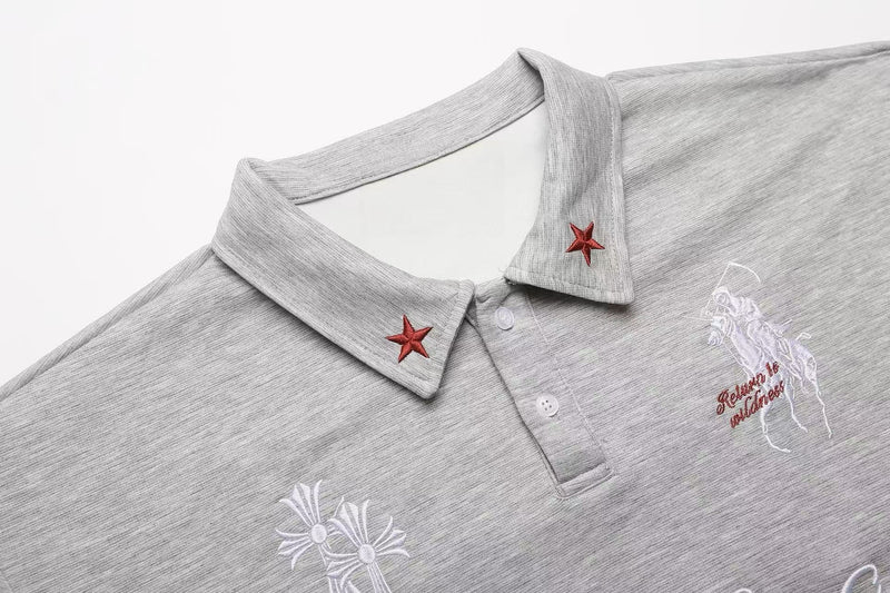 Light gray embroidered polo shirt with red star collar details and gothic graphic on the chest