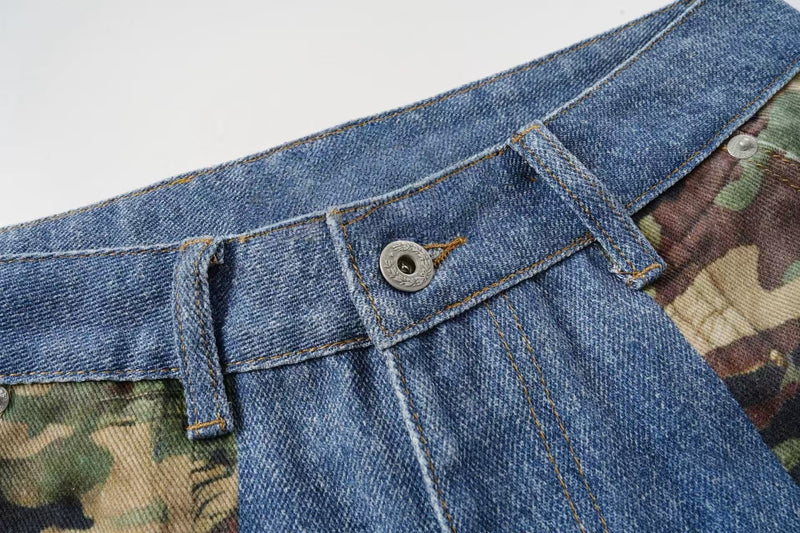 Close-up of denim waistband with button fly and belt loops next to camouflage fabric