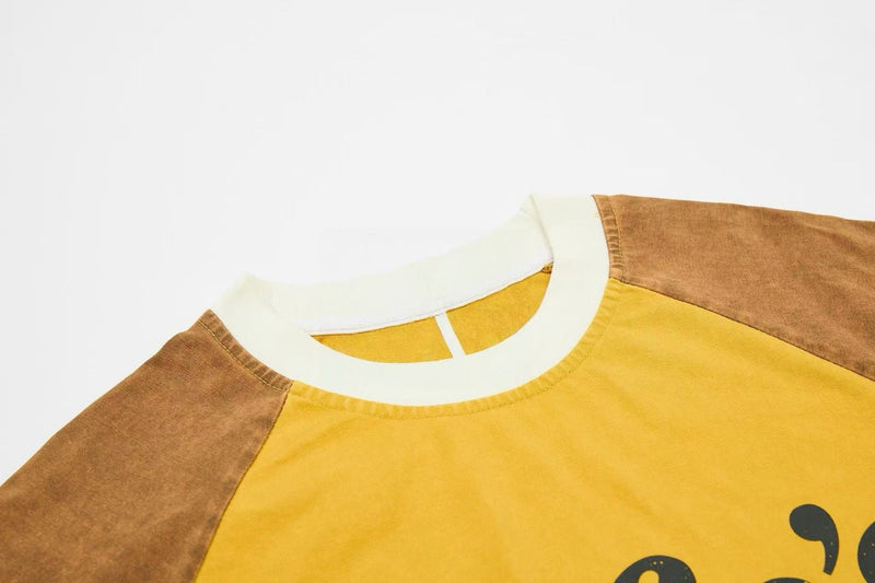 Yellow and brown washed raglan tee with cream collar, vintage streetwear style on a white background