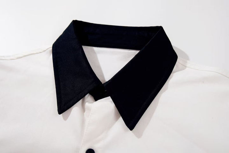 White oversized graphic shirt with a sharp black pointed collar for a clean Y2K streetwear look