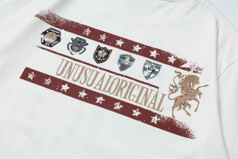 White vintage graphic T-shirt with distressed red star stripes, crest patches, and an equestrian emblem on the chest