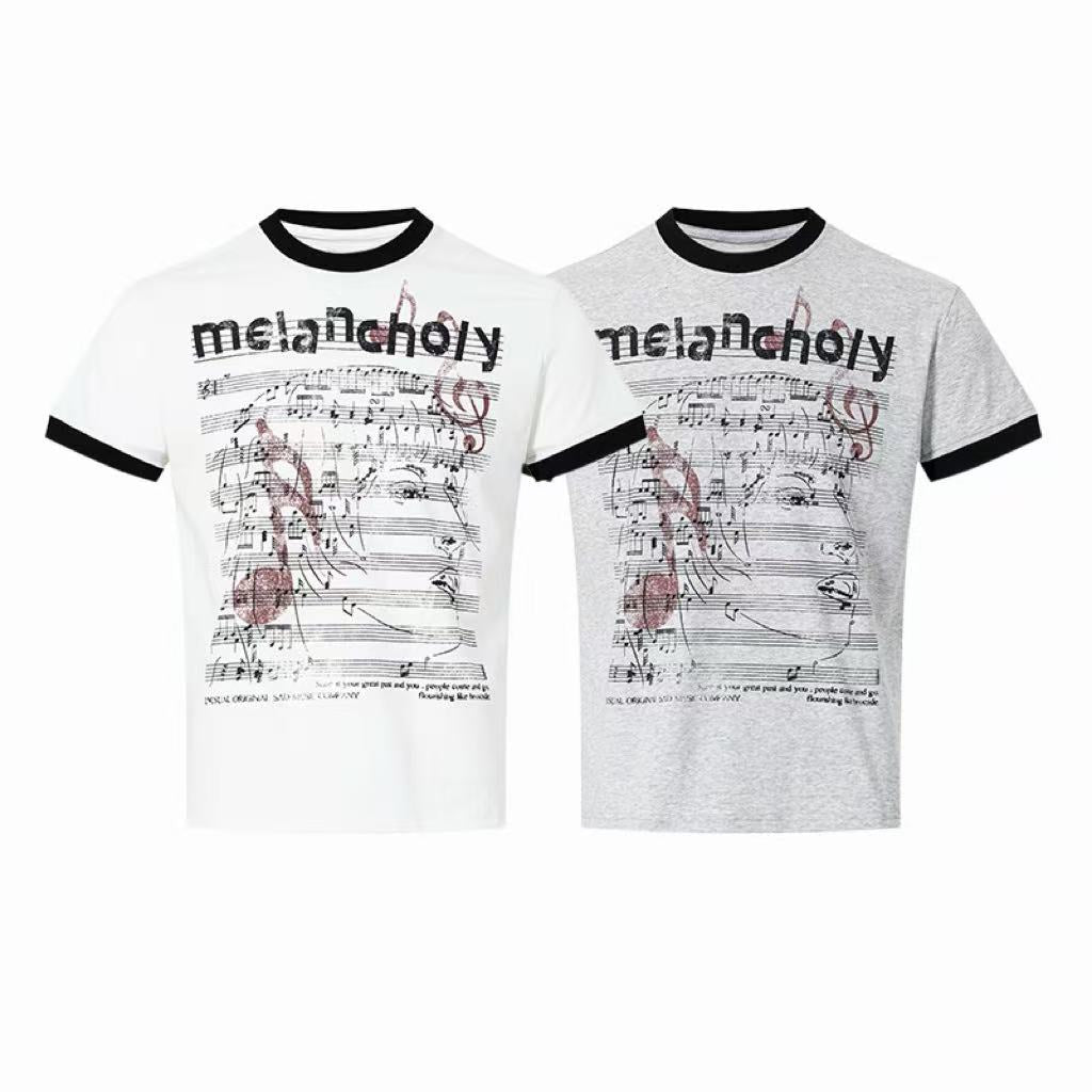 White and grey melancholy graphic ringer t-shirts with music sheet print and contrast black trim, shown side by side