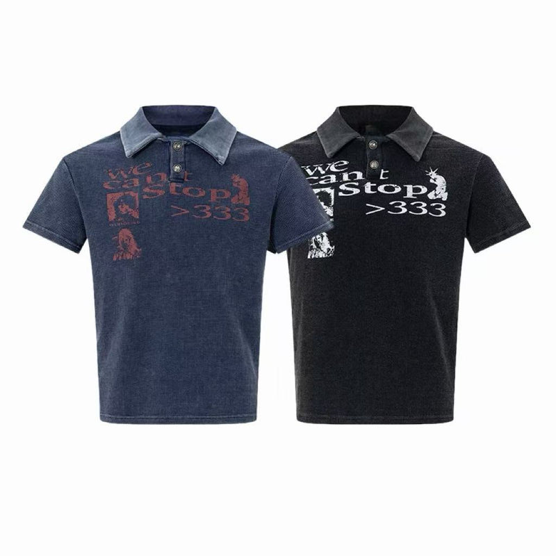 Two vintage washed graphic polo tees in navy and black with faded retro print and contrasting collar