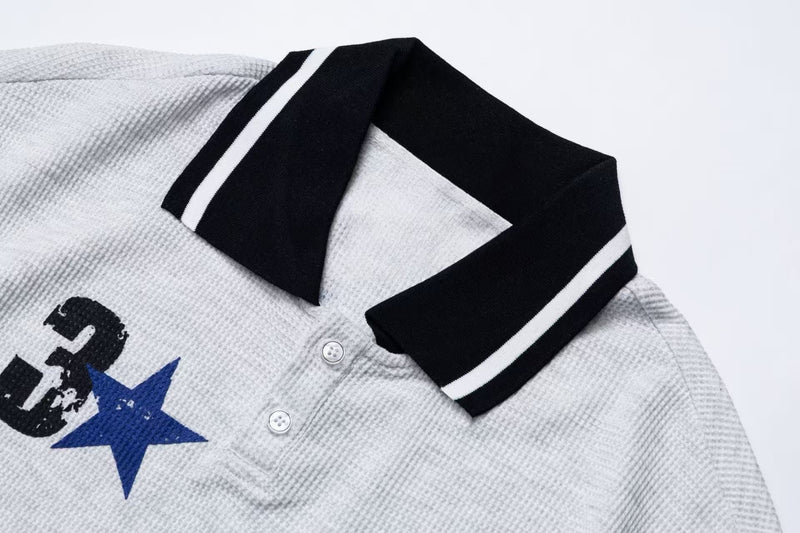 White retro racing polo tee with black striped collar and embroidered star and Mustang graphic