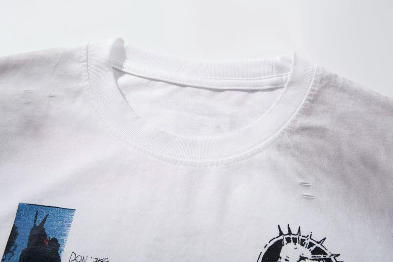 White oversized T-shirt with distressed collar and collage-style graphic print on the chest
