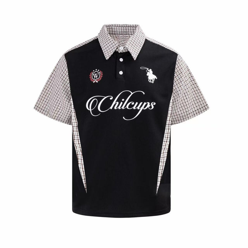 Black oversized polo shirt with plaid panel sleeves, button collar, and vintage-inspired chest graphics