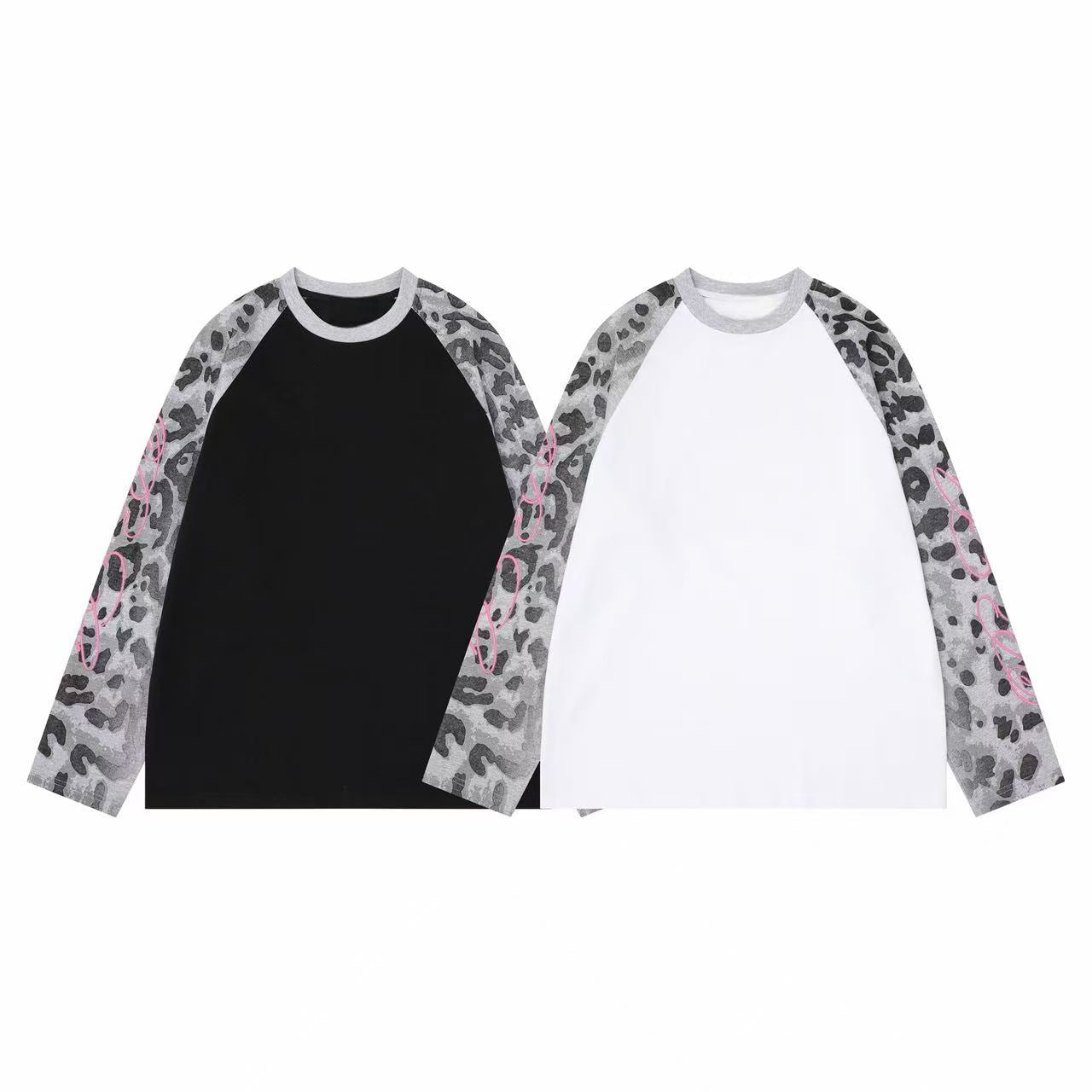 White oversized raglan long sleeve tee with washed grey leopard print sleeves and pink graphic detailing
