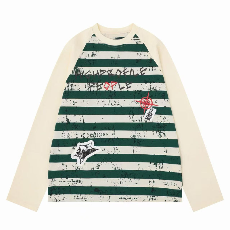 Cream raglan long sleeve tee with dark green stripes, graffiti print, and front patches