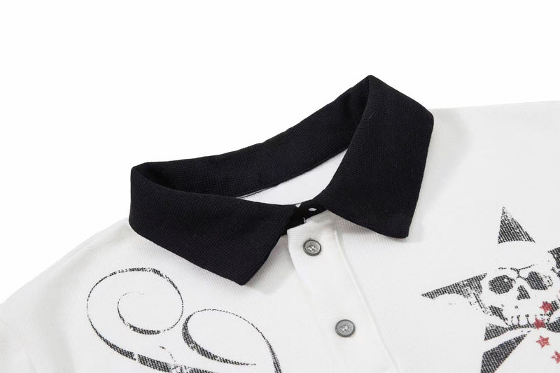 White polo shirt with black contrast collar and gothic skull and star graphic print on the chest